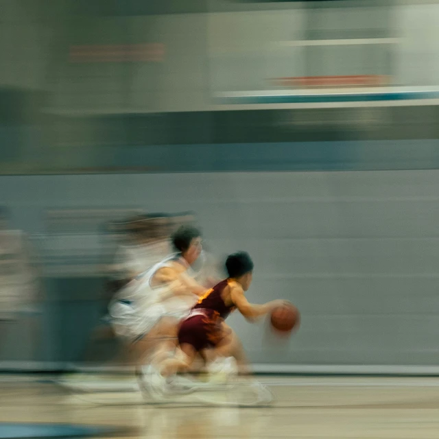 two basketball players are fighting over the ball