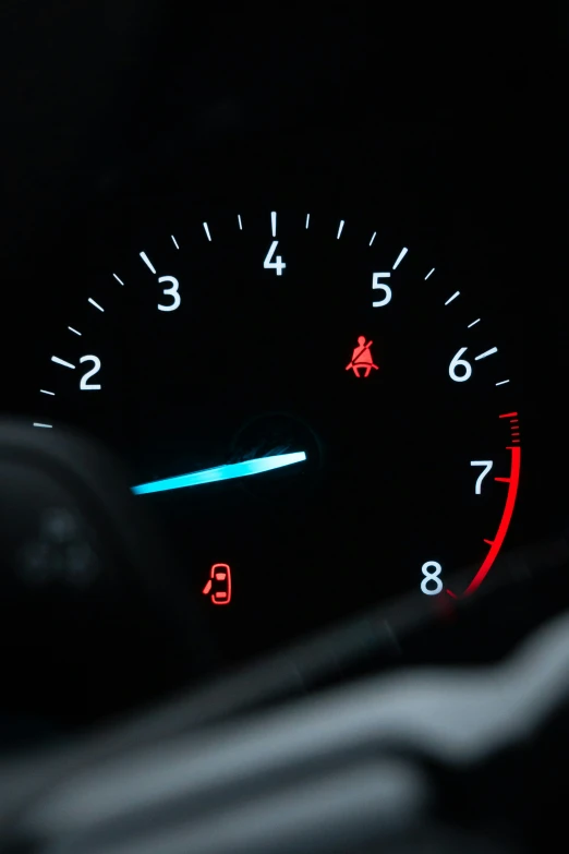 an illuminated meter and indicators are shown in the dark