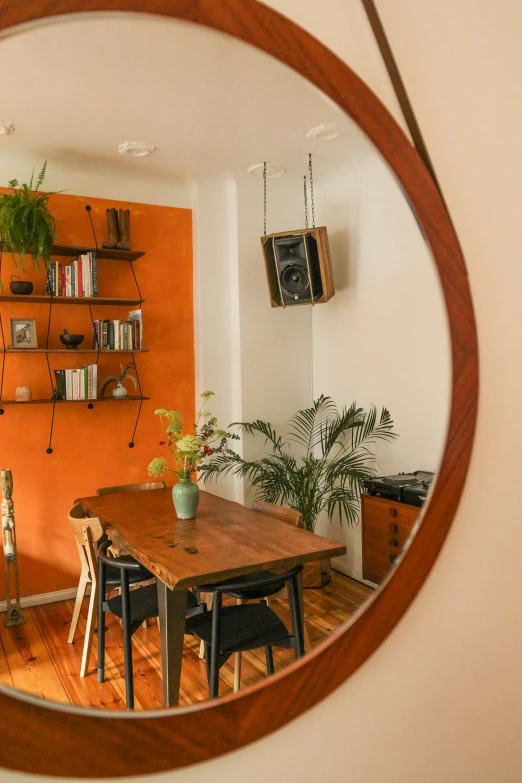 a wood table in a living room with a potted plant