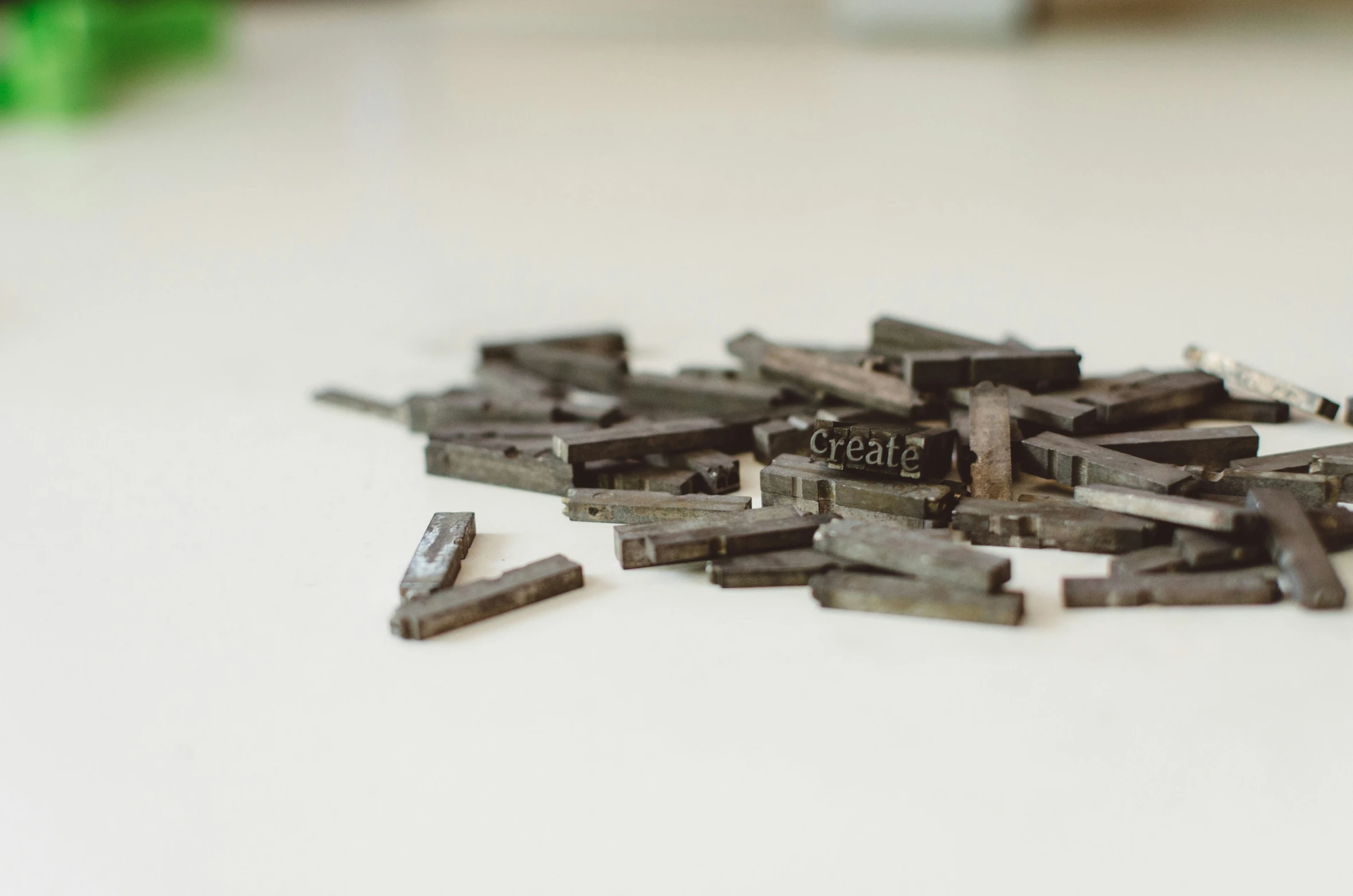 a pile of metal key pieces sitting on top of a white table