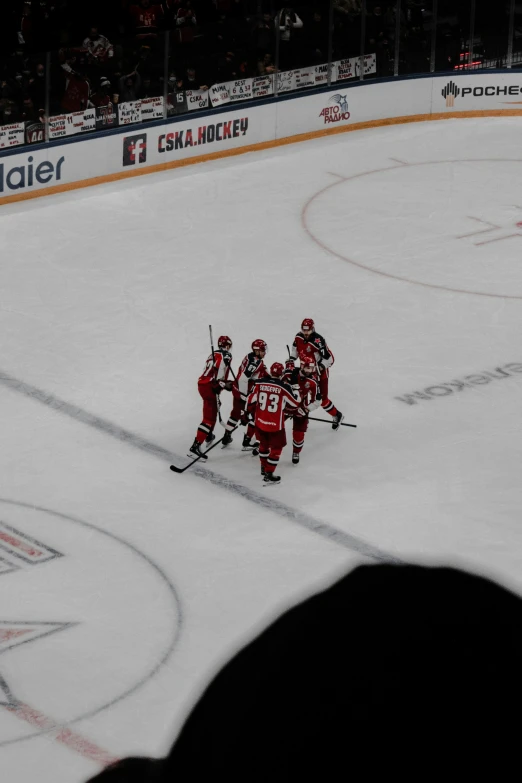 people are playing on the ice at a hockey game