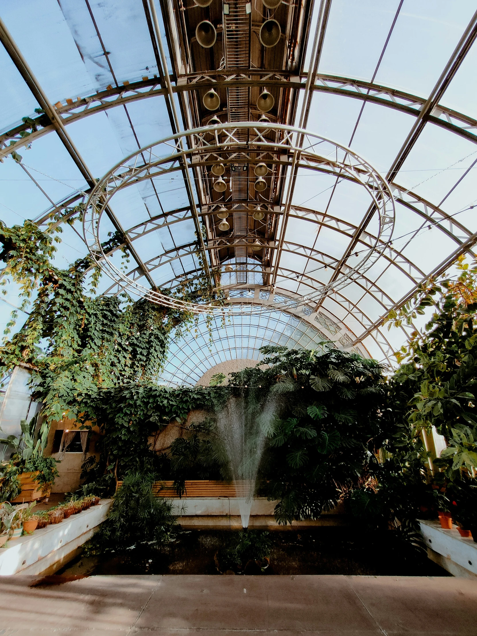 the entrance to a garden is lined with benches