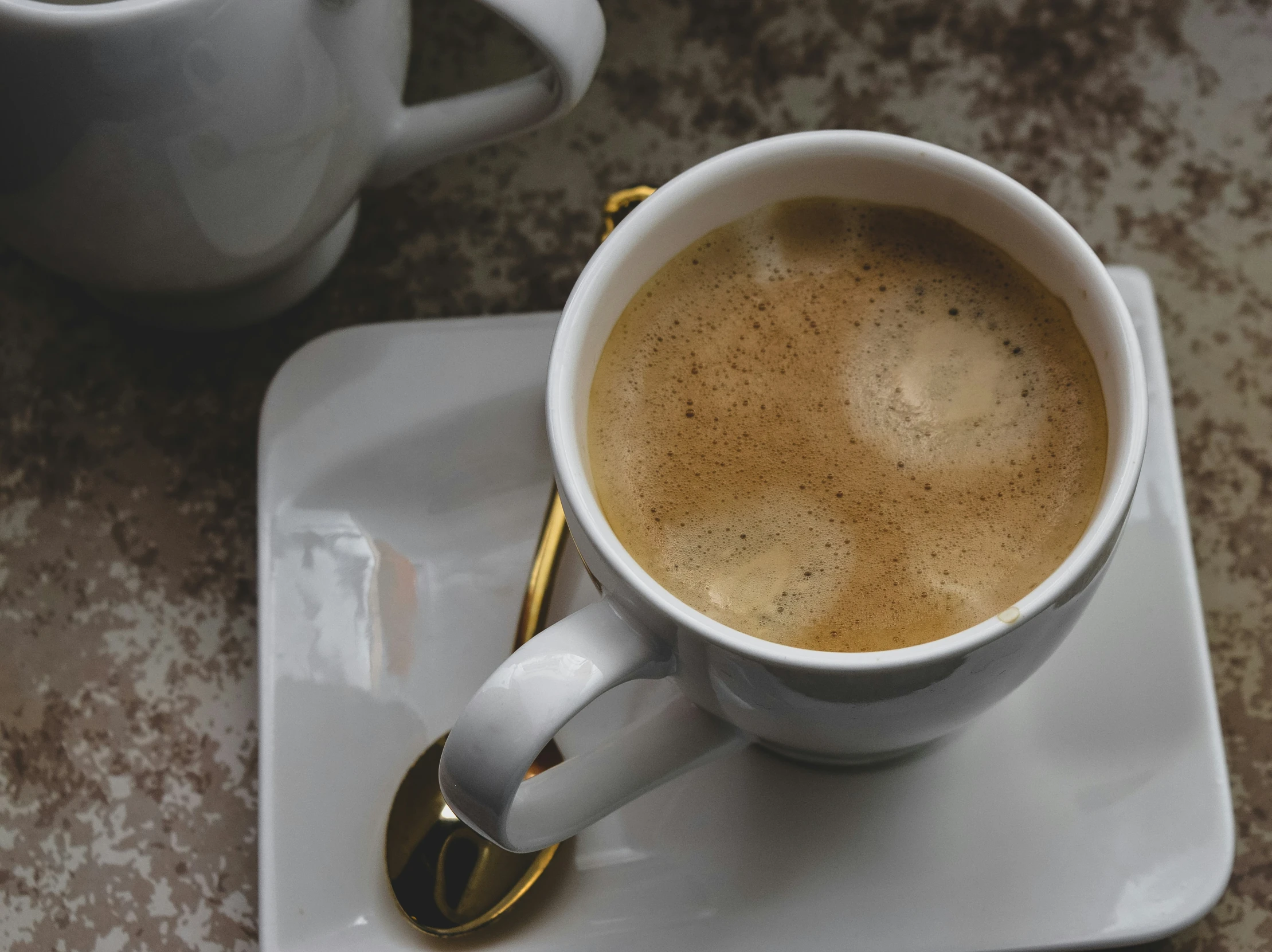 a close up of a coffee cup on a plate