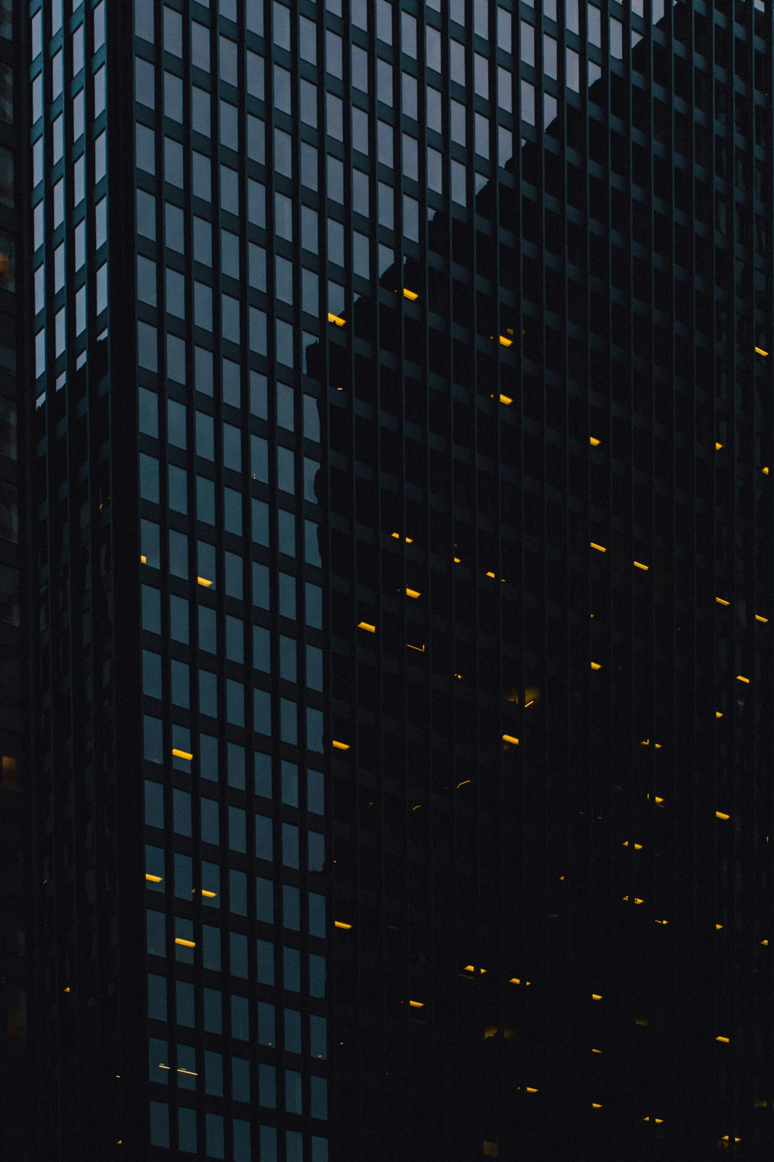 a large bird is flying past tall buildings