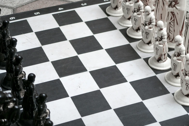 chess game pieces with chess boards lined up on a floor