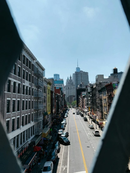 a street in a city viewed through a round window
