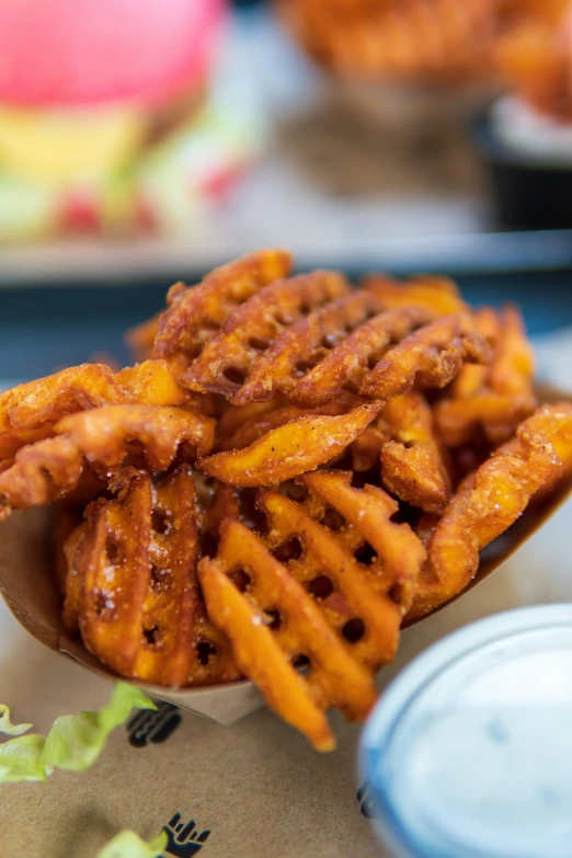 a small bowl full of fried food sits on a table