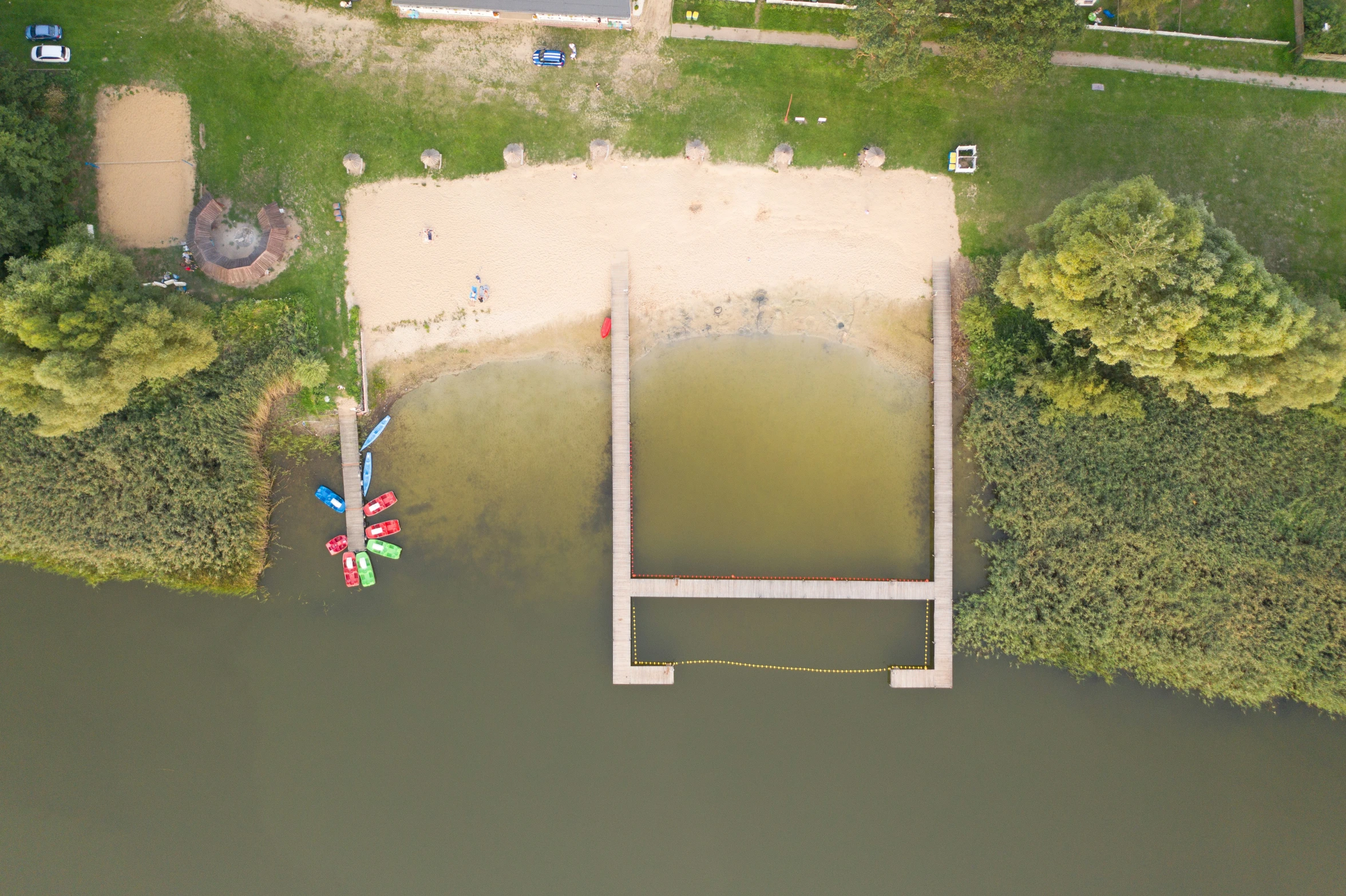 an aerial view of a body of water near a pier