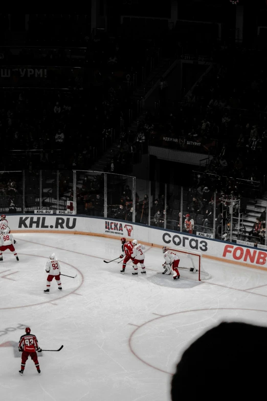 a group of people playing ice hockey on a rink