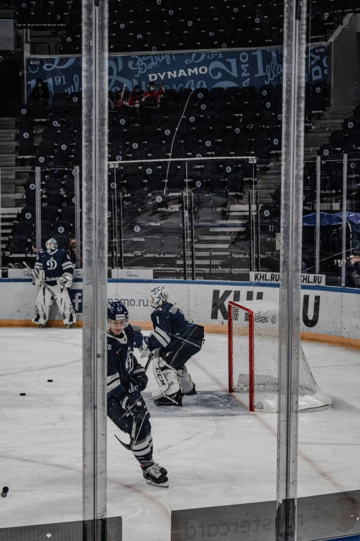 hockey players playing ice hockey in an arena