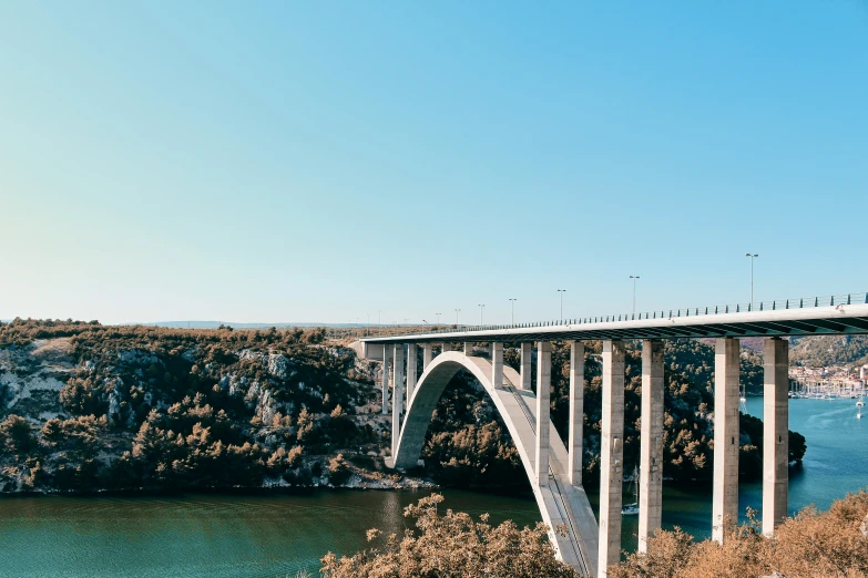 a large long bridge spanning over a river