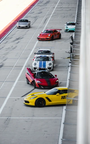some cars driving in a race on a track