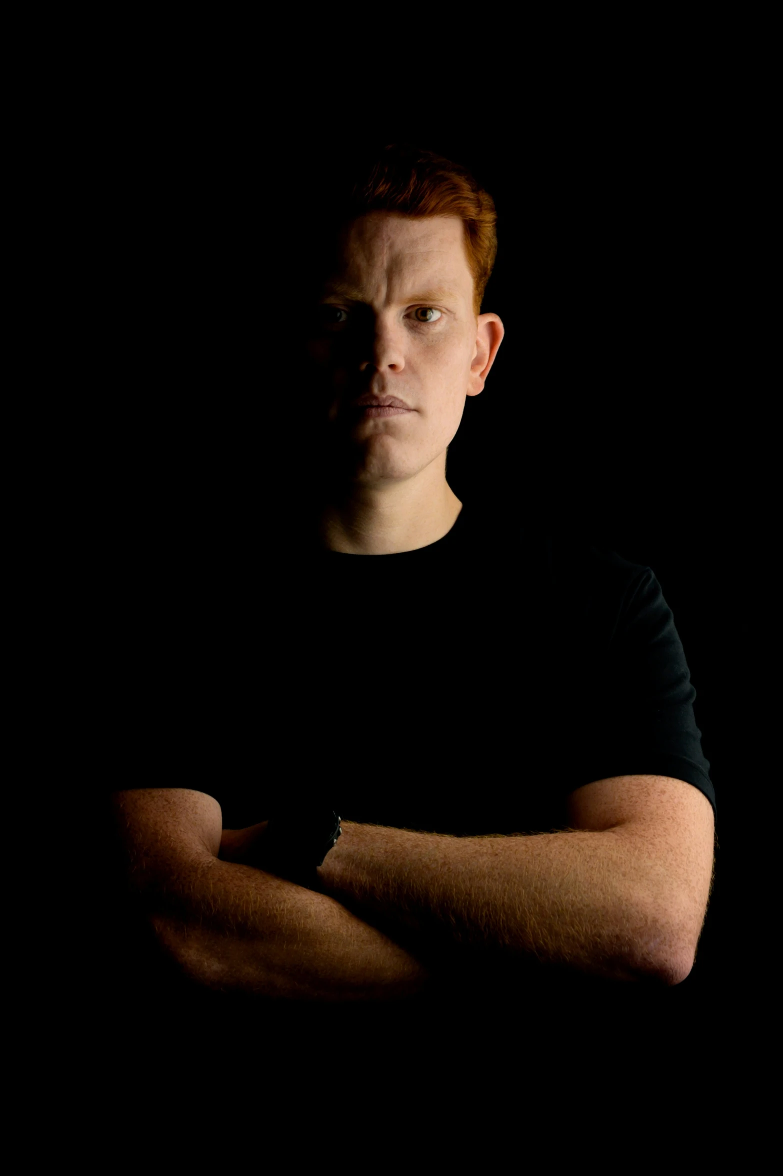 a man with red hair is posing for the camera