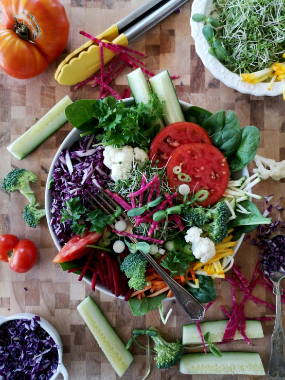 a wooden table with vegetables and vegetables cut up