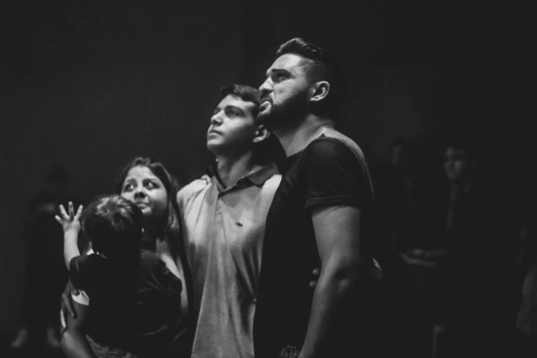 two people standing together and one is waving