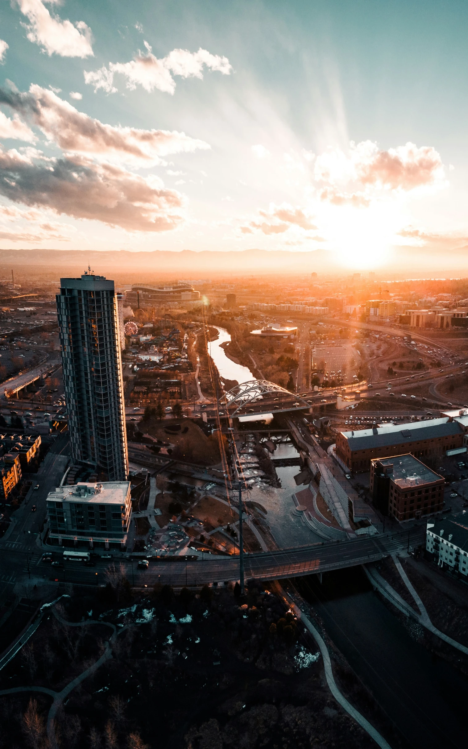 an aerial s shows a sunset over a river and buildings