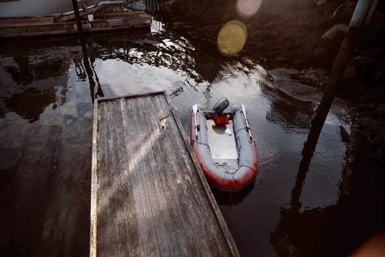 a small boat is docked at the end of the dock