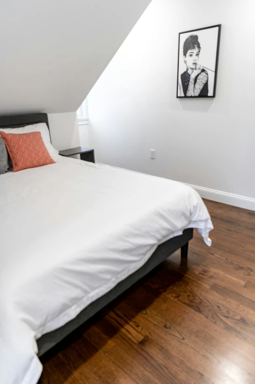 a bedroom with a large bed and white walls