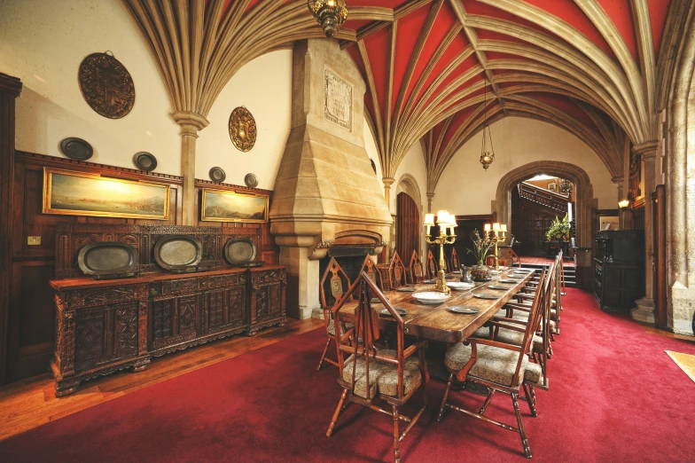 a large dining area has a red carpet and an intricate ceiling