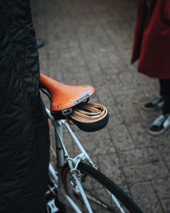 a brown leather seat sitting on top of a bike