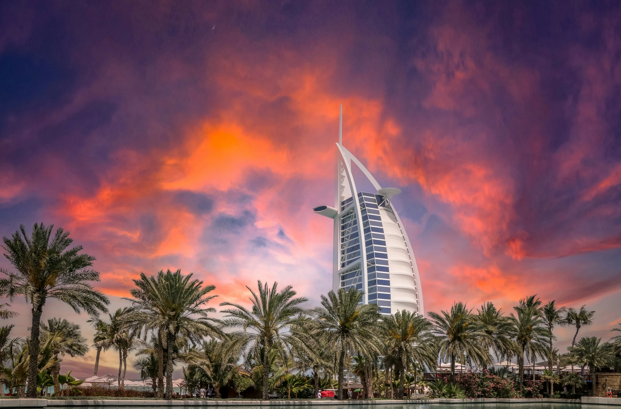 the burj is silhouetted against the vint sky