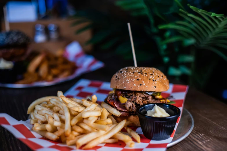 a plate that has french fries, a hamburger and a drink