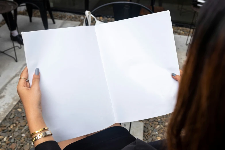 a woman holding a white piece of paper with some writing on it