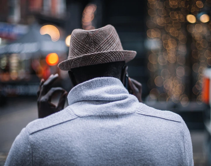 the man is talking on his phone in the street