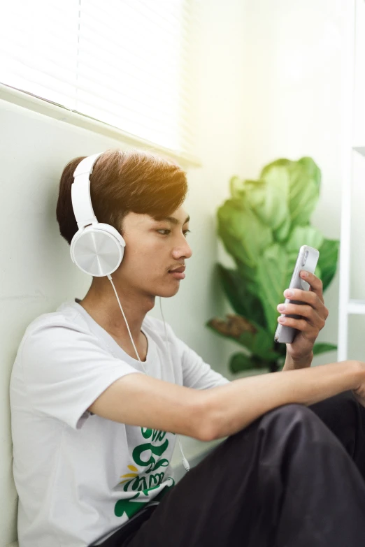 a man that has headphones on with a remote