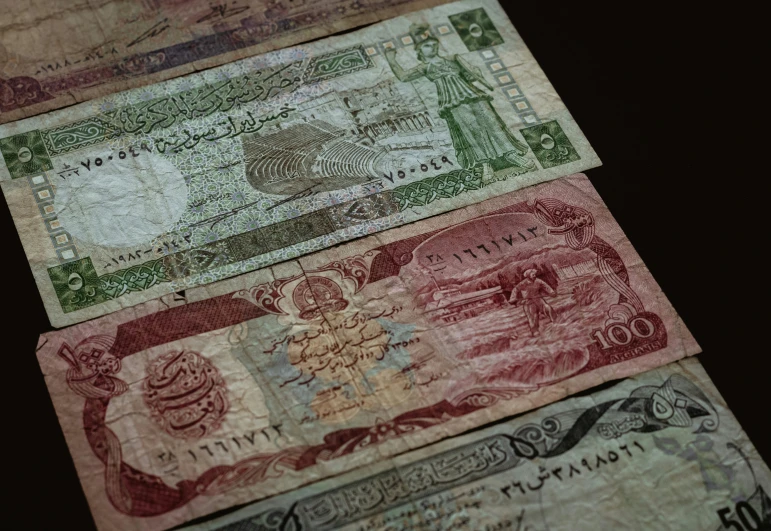 three different british pounds notes each with different names