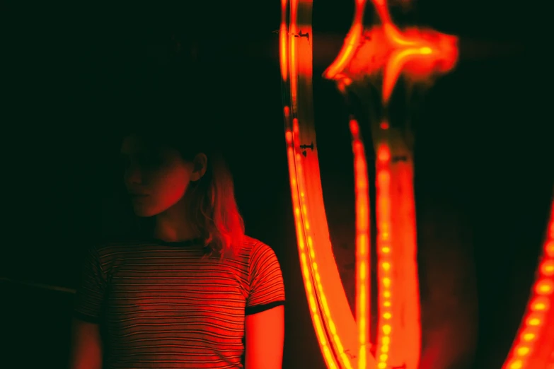 girl standing in front of an outdoor lighted area