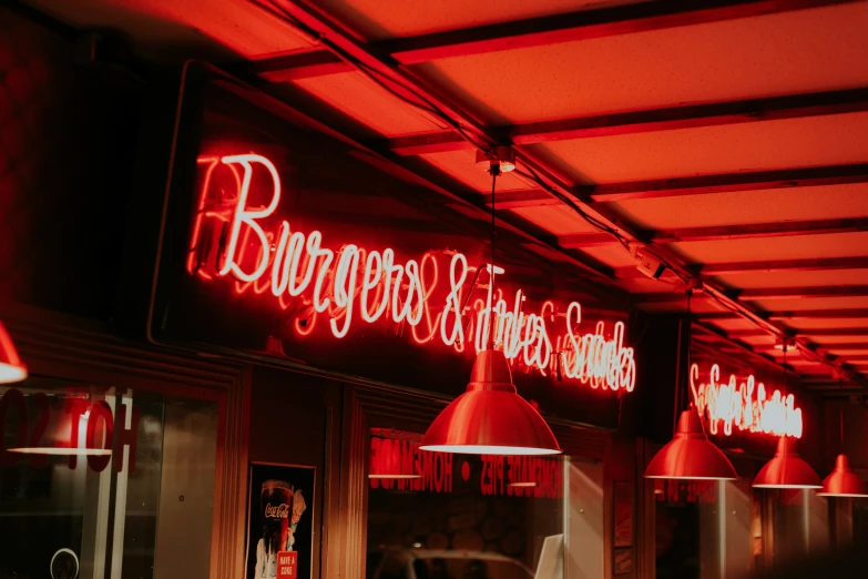 red neon lights illuminate the interior of a restaurant