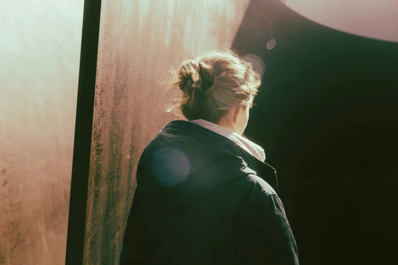 a woman with a ponytail is standing in a doorway