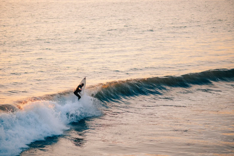 a person in a wetsuit surfing in the ocean