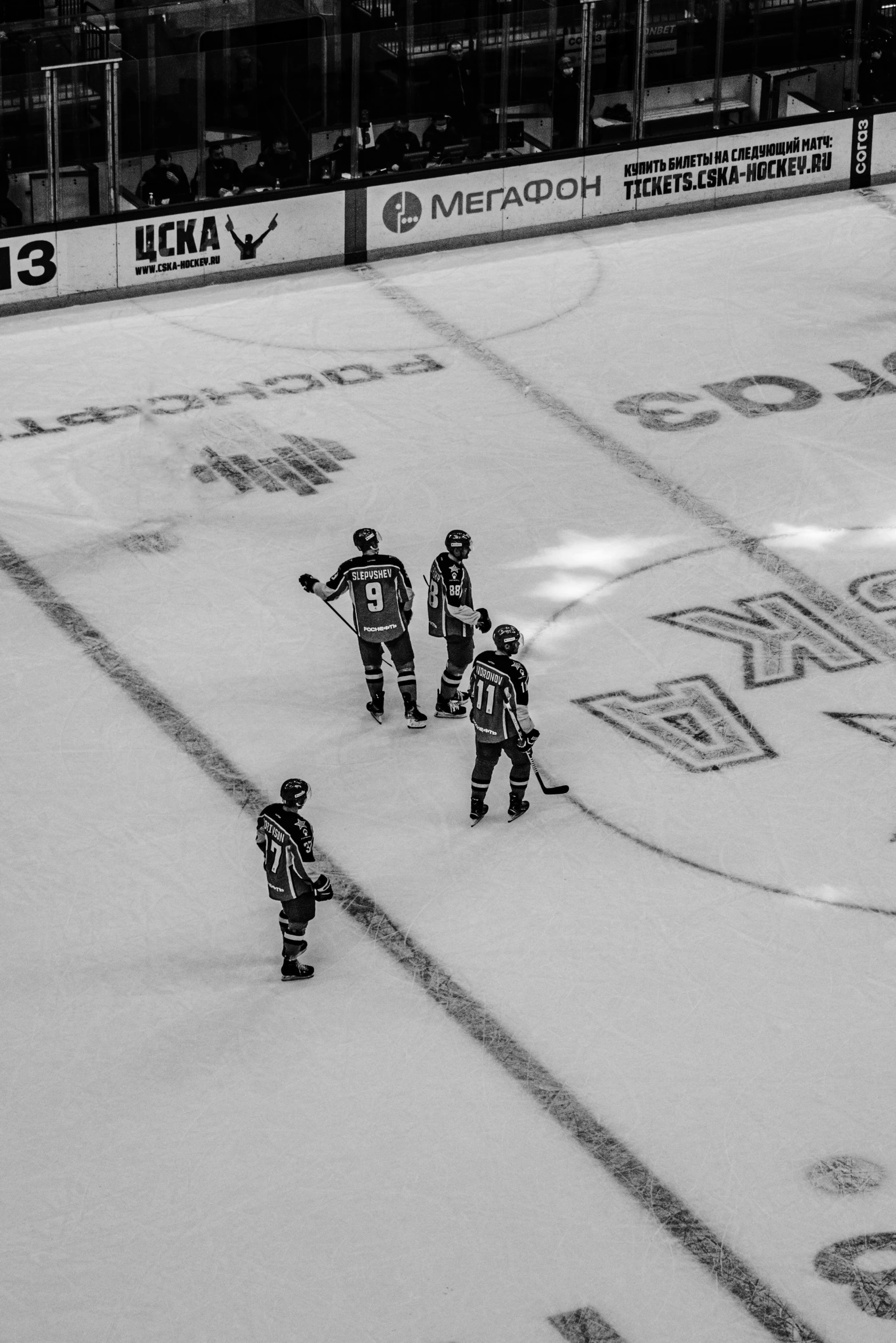 a hockey team on the ice talking to a referee