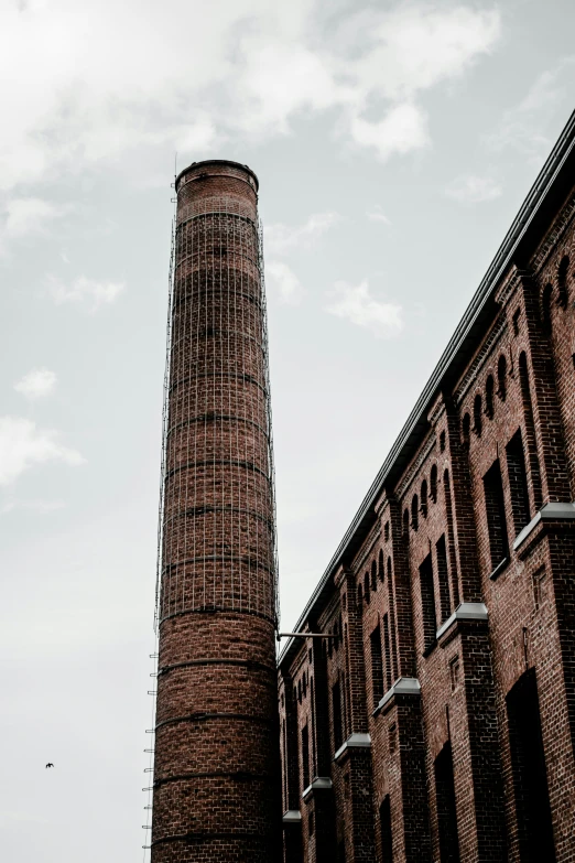 the brick chimney in this old factory is being restored