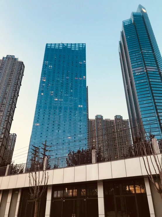 a couple of tall buildings sitting above a street