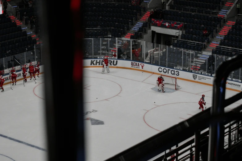 a hockey rink with a few players on the ice