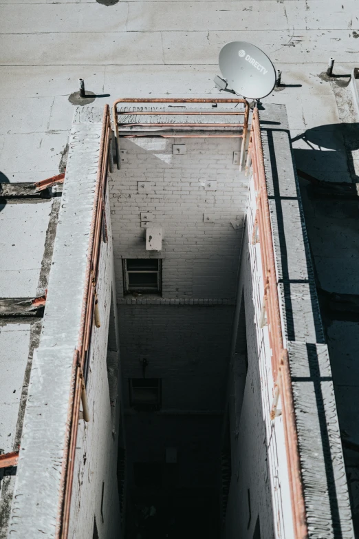 an unfinished area with an old mirror and satellite dish on the top