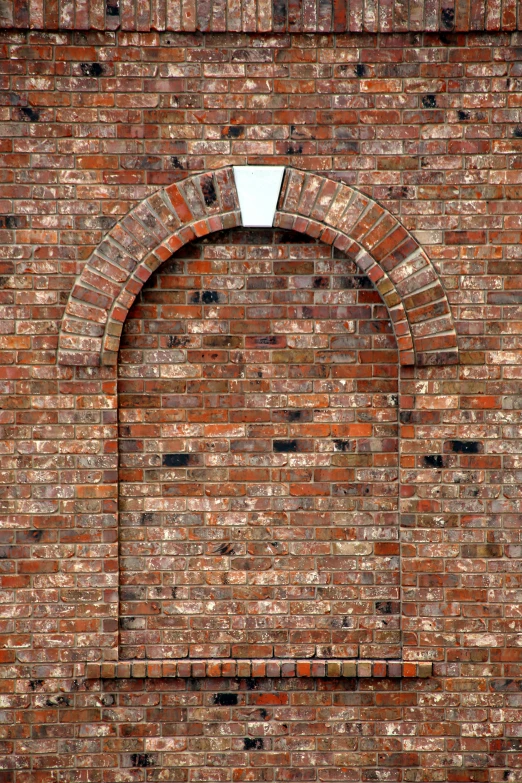a close up of an arched brick wall