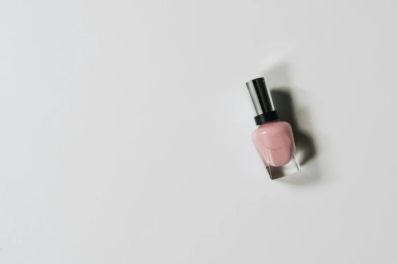 pink nail polish on a white background