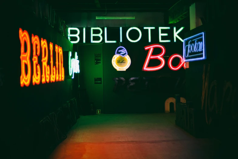 a tunnel filled with neon signs on the side of it