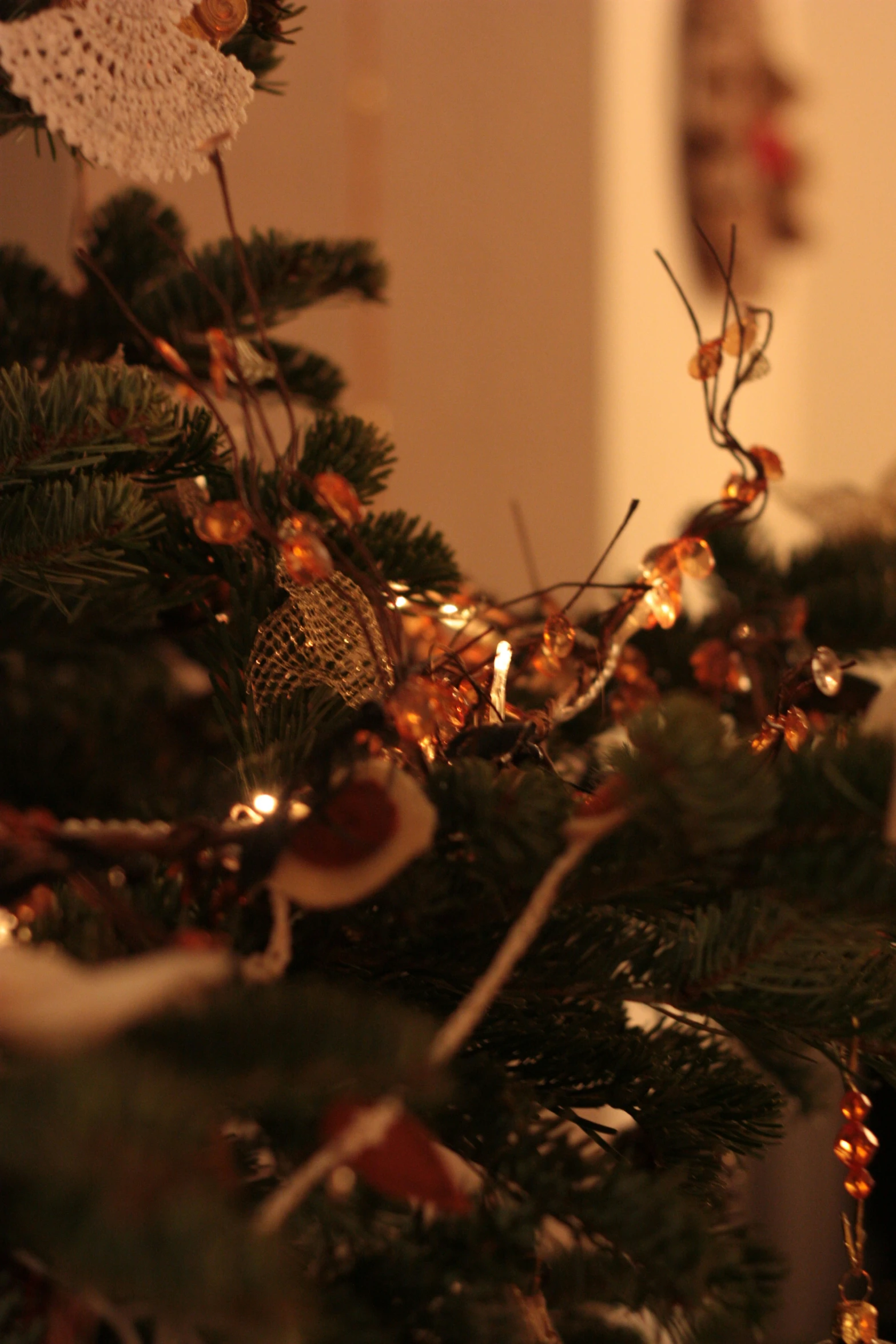 a christmas tree has lights on it and a red bow