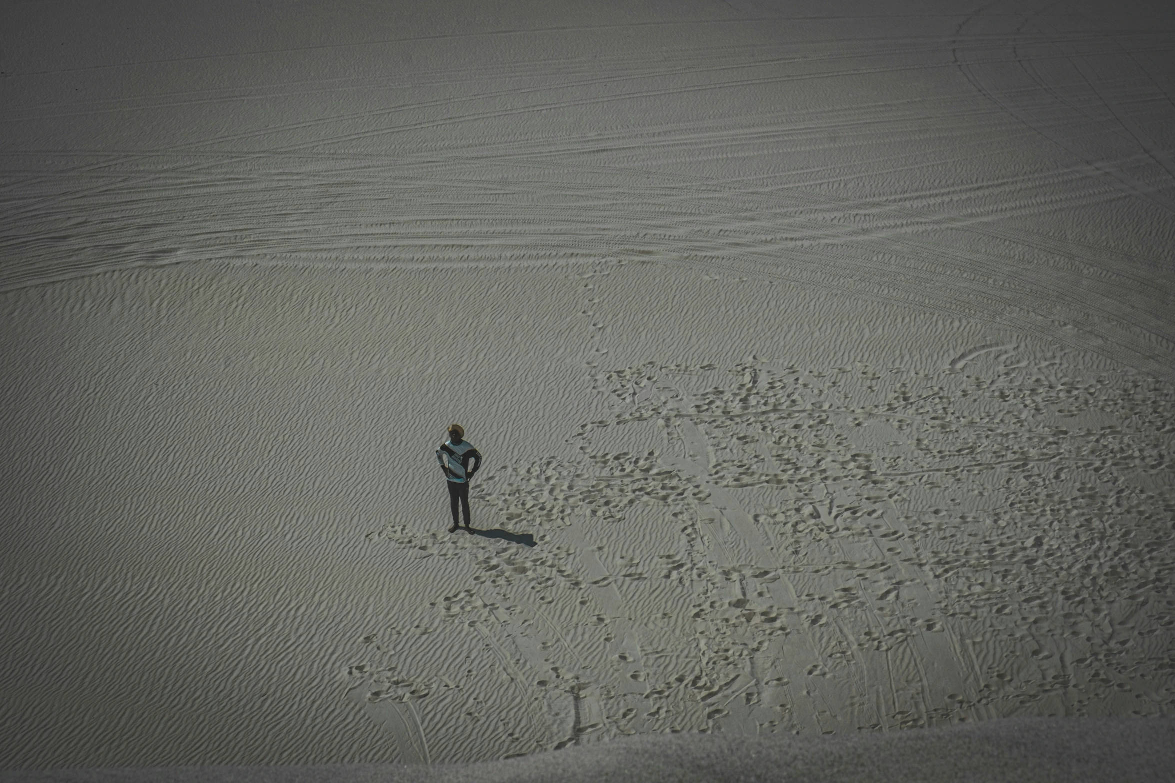 a man is standing in the sand in the desert