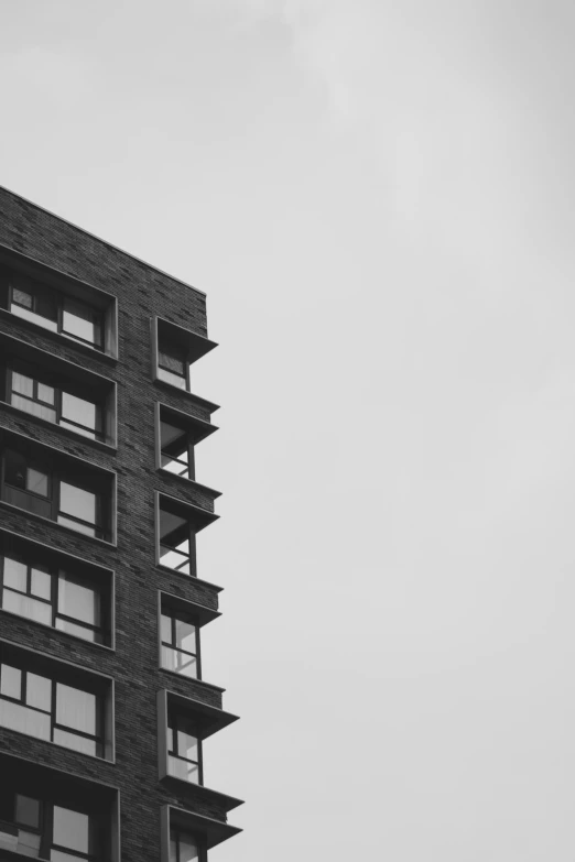 a black and white po of a building under a cloudy sky