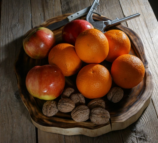 a bowl filled with some apples and some nuts