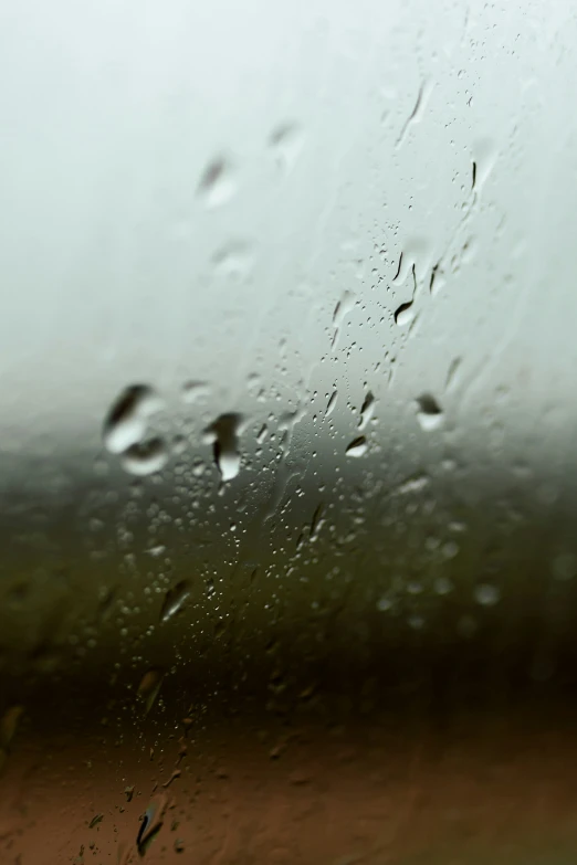 water drops on a glass with dirt ground behind