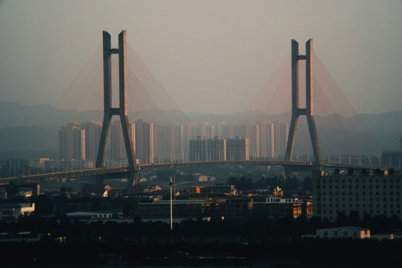 large bridge near large city with skyscrs in background