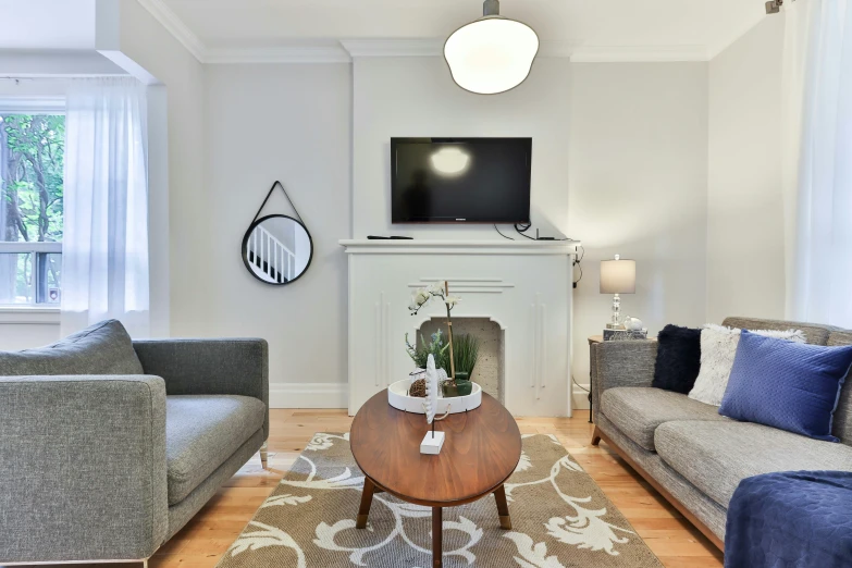 living room with couches and table surrounded by curtains