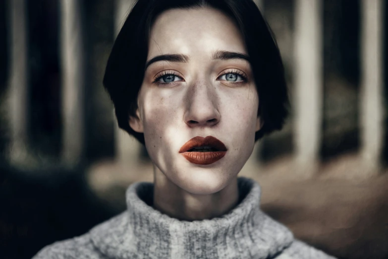 a woman with dark hair and orange lips